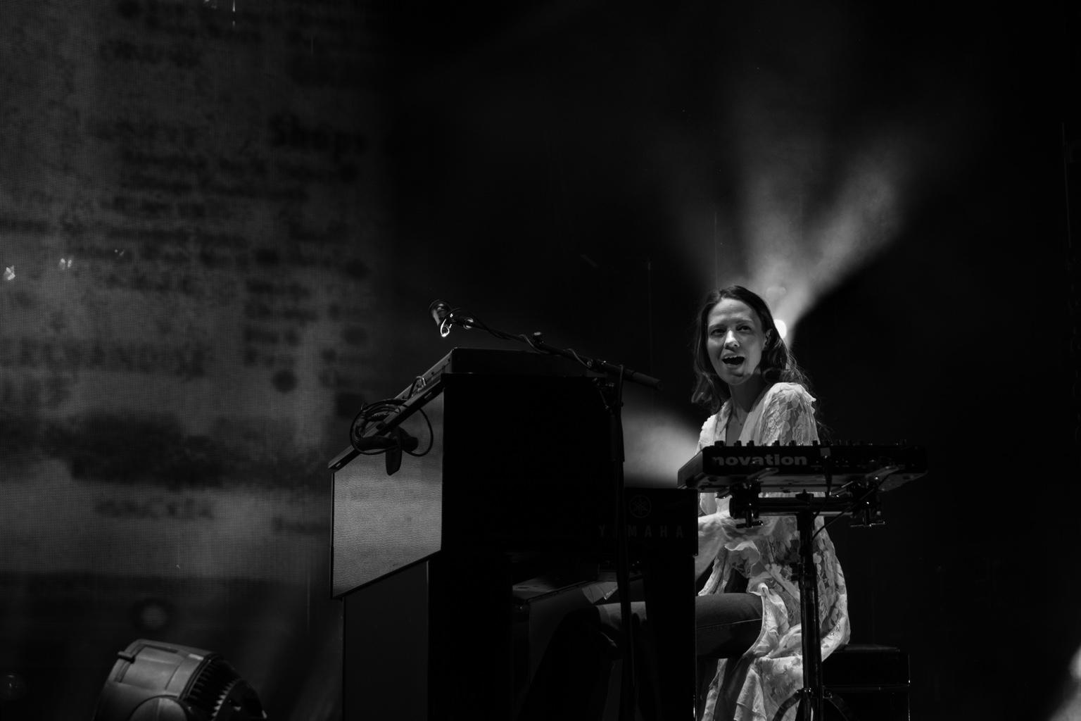 A keyboardist performs beside a Yamaha piano